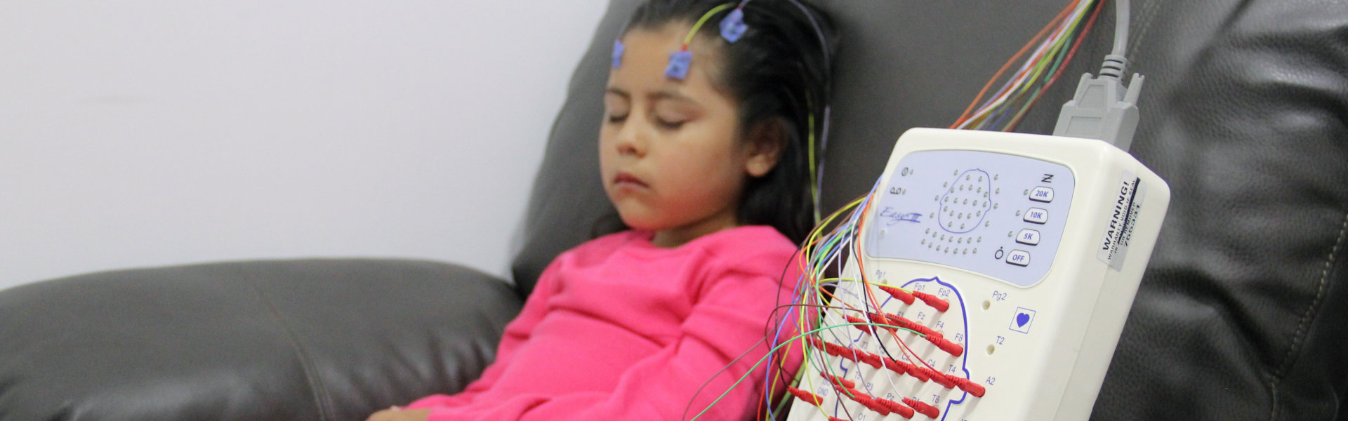 a child with wires on her head